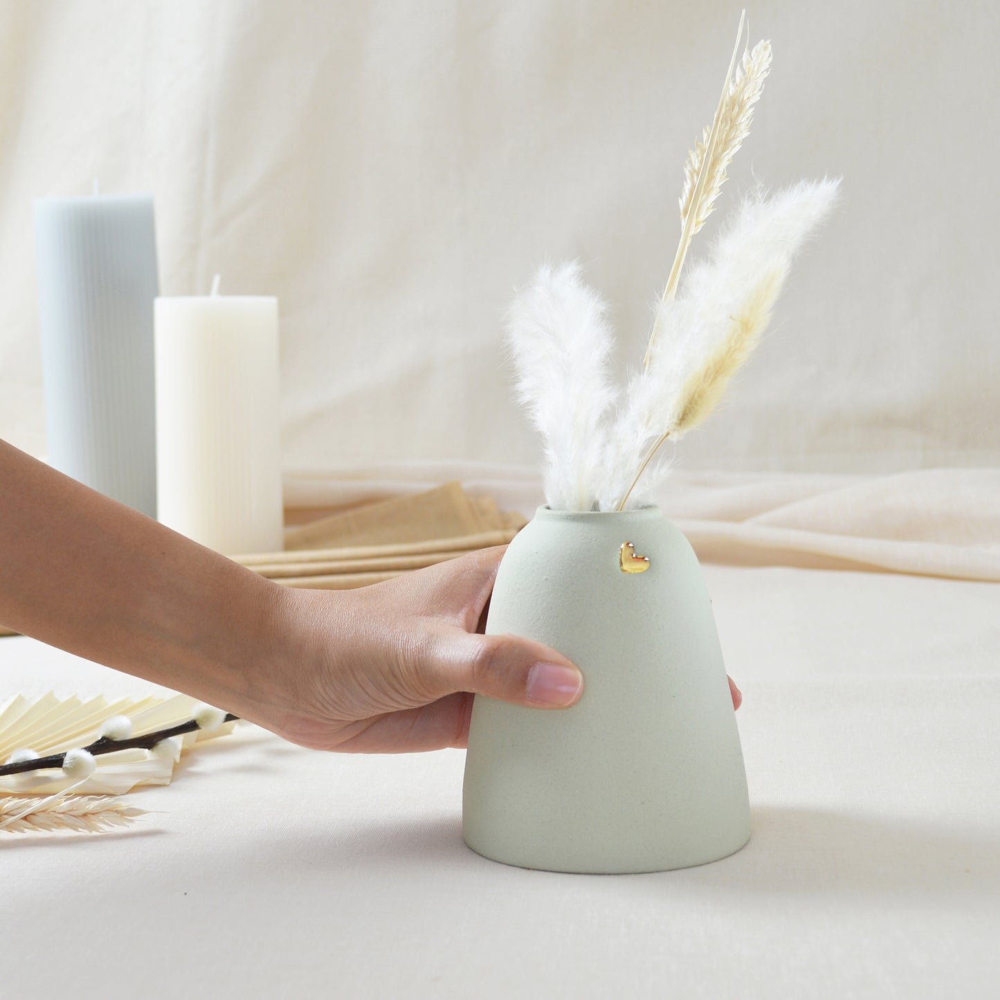 Handmade pastel mint vase with a short rim and gold heart.