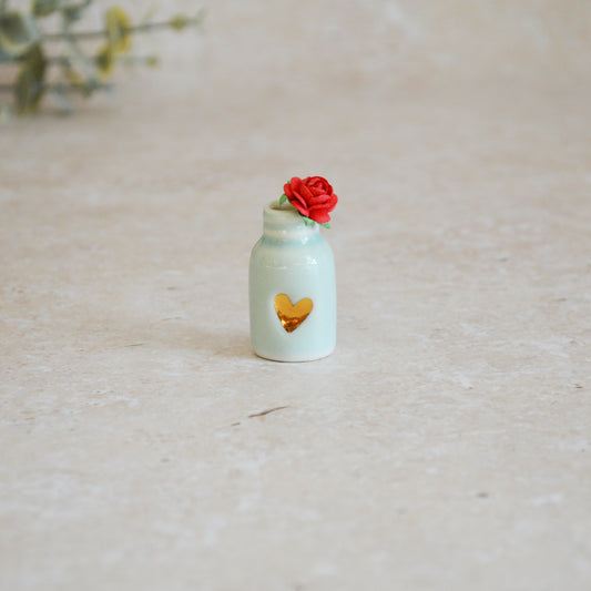 Seconds* Discontinued* Glazed Mini Bottle with an Embossed Gold Heart and a Red Paper Rose A113