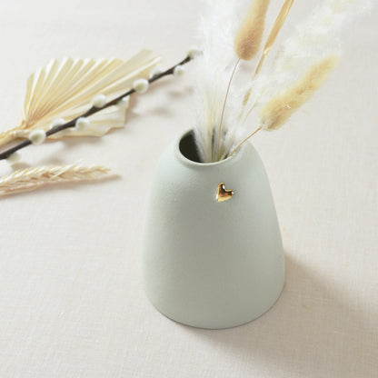 Top View of the handmade pastel mint vase with a short rim and gold heart.