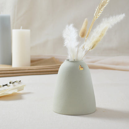 Handmade pastel mint vase with a short rim and gold heart.