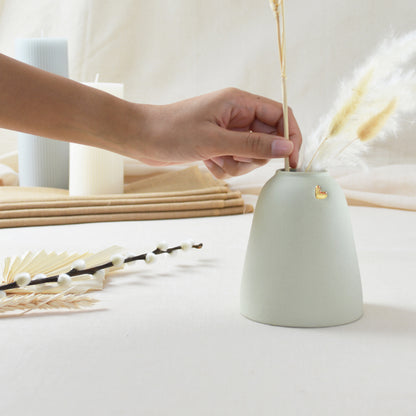 Handmade pastel mint ceramic vase with a gold heart