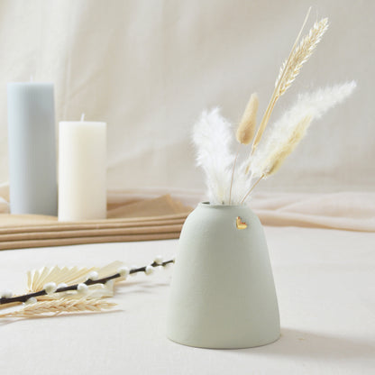 Handmade pastel mint vase with a short rim and gold heart.